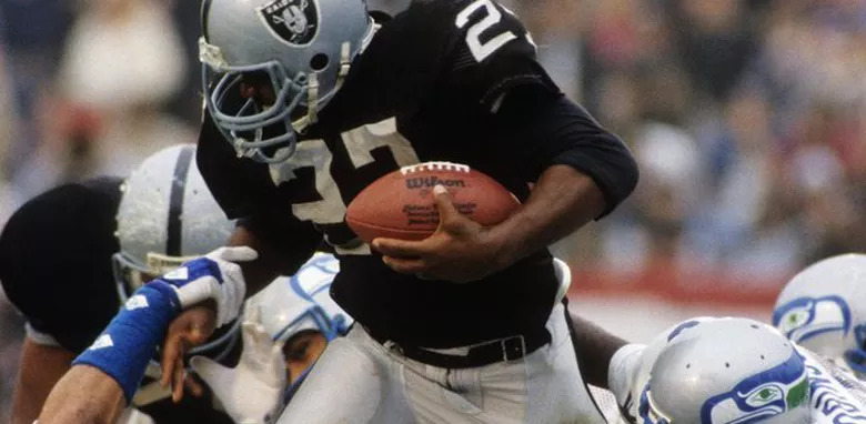 Los Angeles Raiders' veteran running back Frank Hawkins (27) heads