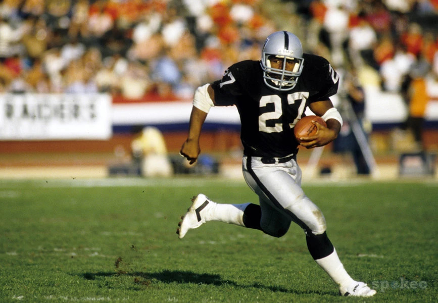 Los Angeles Raiders' veteran running back Frank Hawkins (27) heads