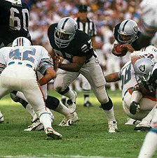 Los Angeles Raiders' veteran running back Frank Hawkins (27) heads